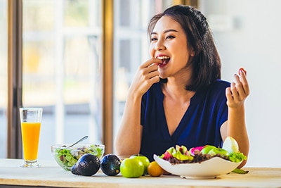 woman eating various fruits