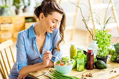 Young woman eating healthy salad