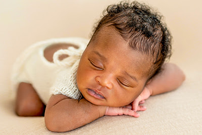 Sleeping baby in a white dress