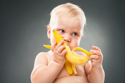 Baby eating banana